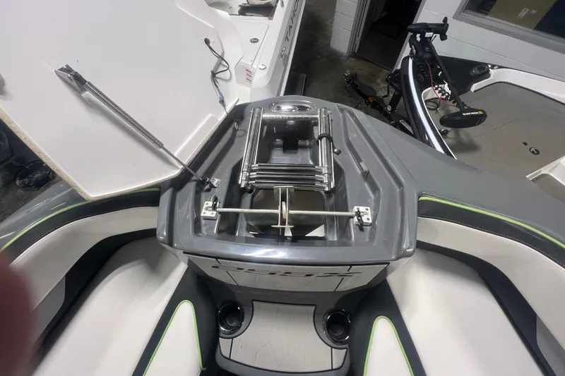 Slide: The Image of 2021 Yamaha Boats 255XD interior with open storage compartment and sleek design. - 31