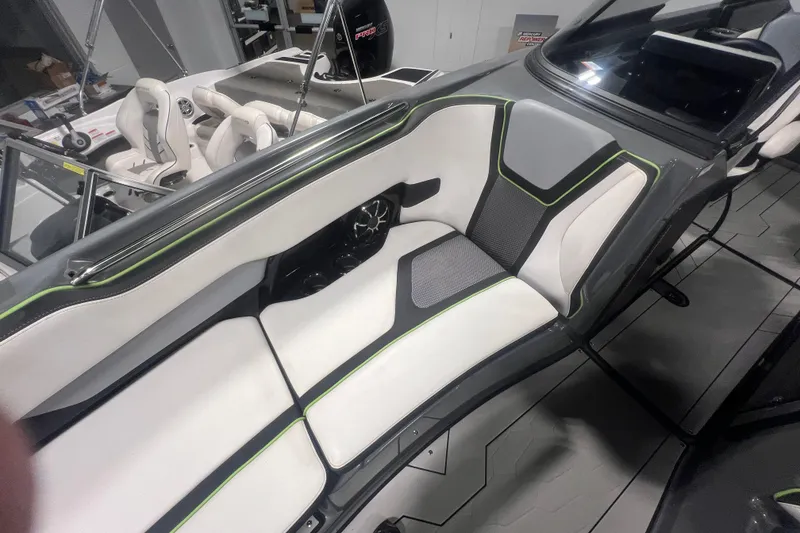 Slide: The Image of 2021 Yamaha Boats 255XD interior with sleek white and gray seating, accented by green trim. - 33