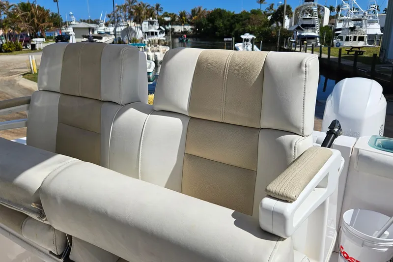 Slide: The Image of 2015 Everglades 255 Center Console boat seats at marina, showcasing luxury and comfort. - 12