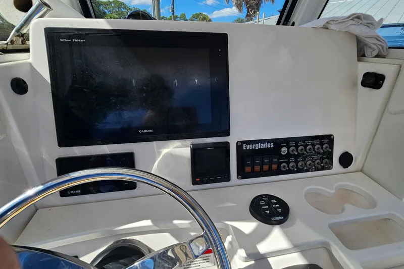 Slide: The Image of 2015 Everglades 255 Center Console dashboard with Garmin display and control panel. - 16