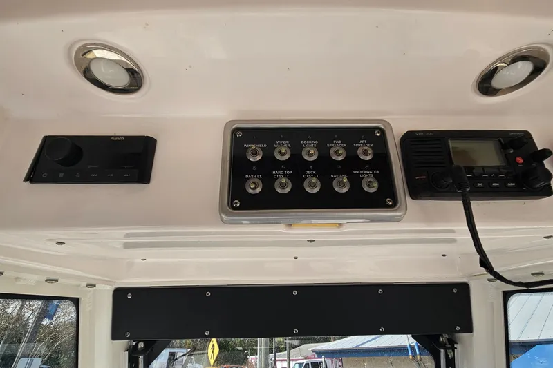 Slide: The Image of Control panel of a 2015 Everglades 255 Center Console boat with switches and radio. - 19