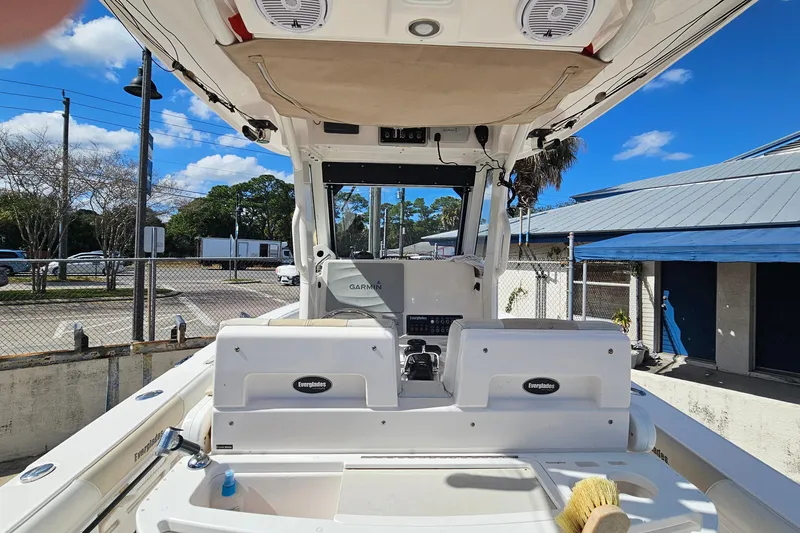Slide: The Image of 2015 Everglades 255 Center Console boat interior with Garmin equipment, docked under blue sky. - 20
