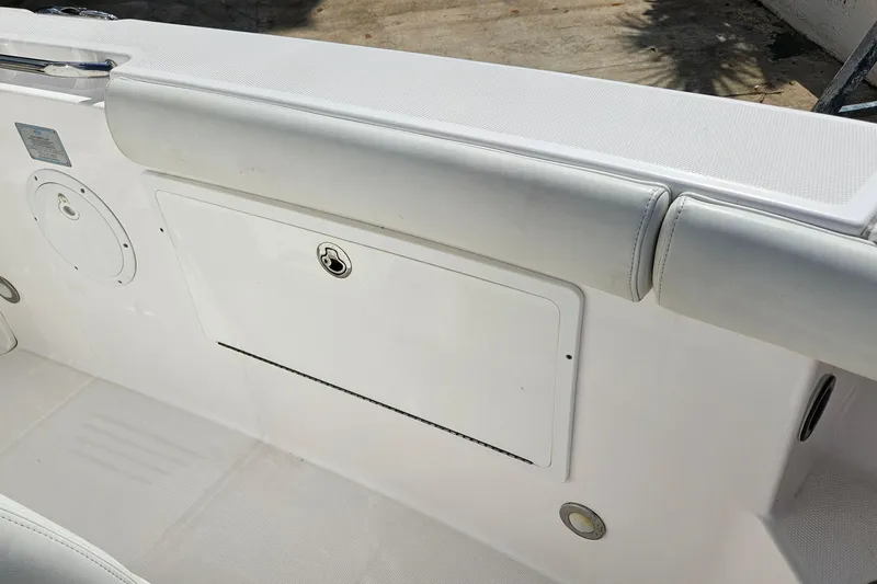 Slide: The Image of 2015 Everglades 255 Center Console boat interior with storage compartment and cushioned seating. - 25