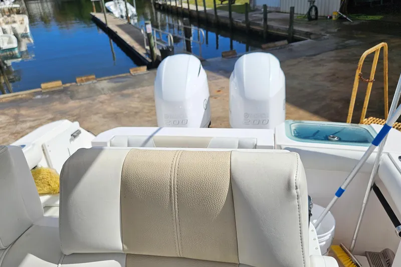 Slide: The Image of 2015 Everglades 255 Center Console boat with twin engines at a dock. - 27