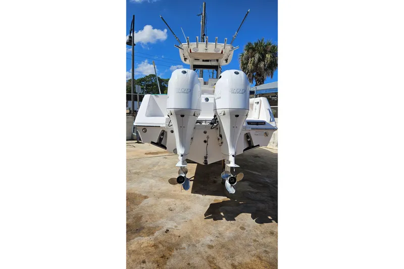 Slide: The Image of 2015 Everglades 255 Center Console boat with twin outboard engines, docked outdoors. - 28