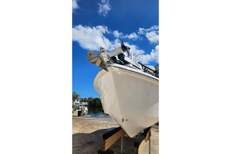 Slide: The Image of 2015 Everglades 255 Center Console boat on stand under blue sky. - 29