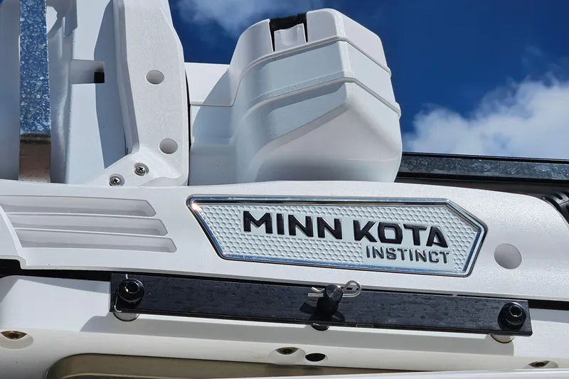 Slide: The Image of Minn Kota Instinct motor on 2015 Everglades 255 Center Console boat, under blue sky. - 33