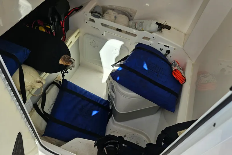 Slide: The Image of Interior storage of 2015 Everglades 255 Center Console boat with safety equipment. - 35