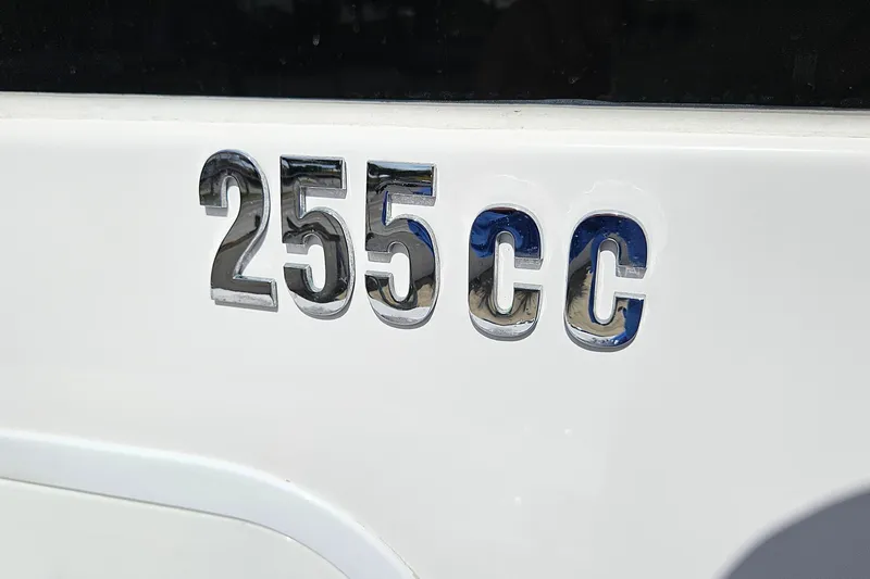 Slide: The Image of Everglades 255 Center Console 2015 boat emblem in chrome on white surface. - 44