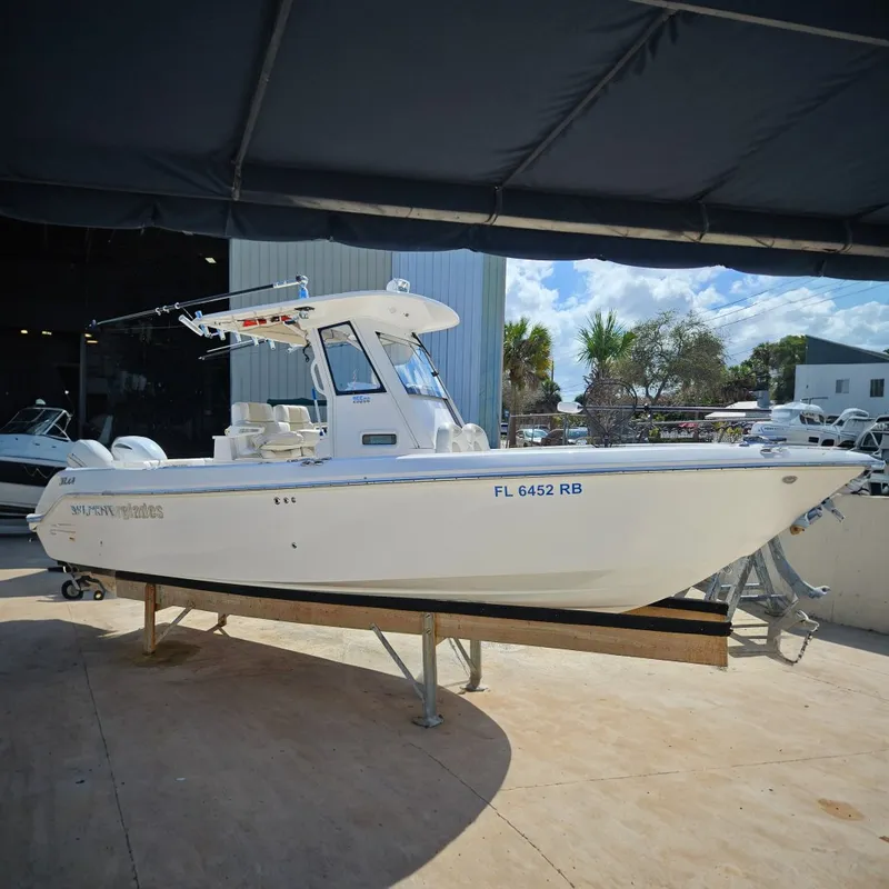 The Image of 2015 Everglades 255 Center Console boat on display, sunny day, outdoor setting. - 0