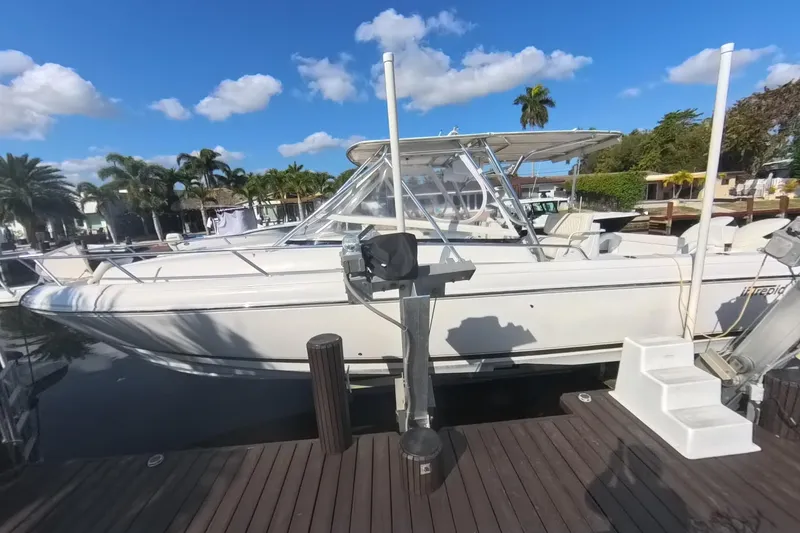 Slide: The Image of 2005 Intrepid 348 Walkaround boat docked under a clear blue sky. - 16