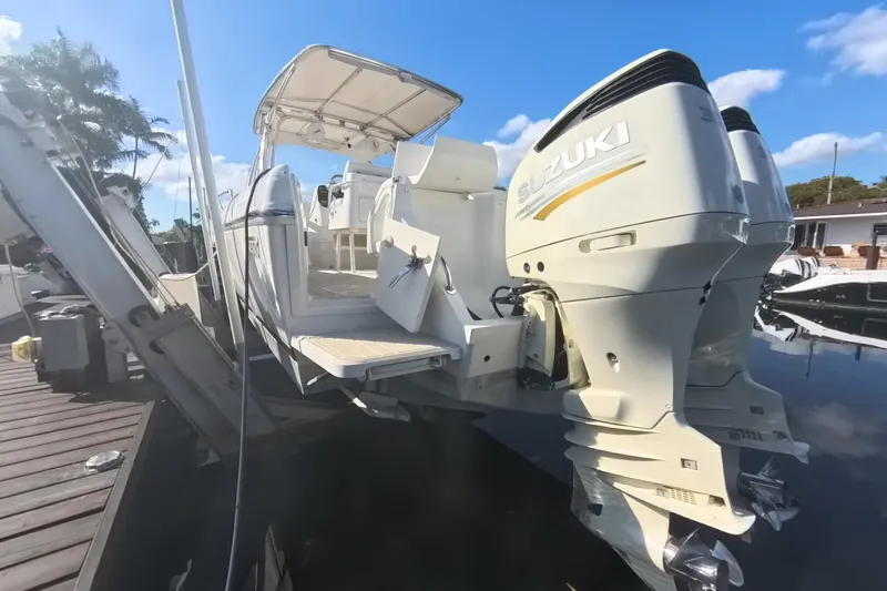 Slide: The Image of 2005 Intrepid 348 Walkaround boat with dual Suzuki outboard engines docked. - 18