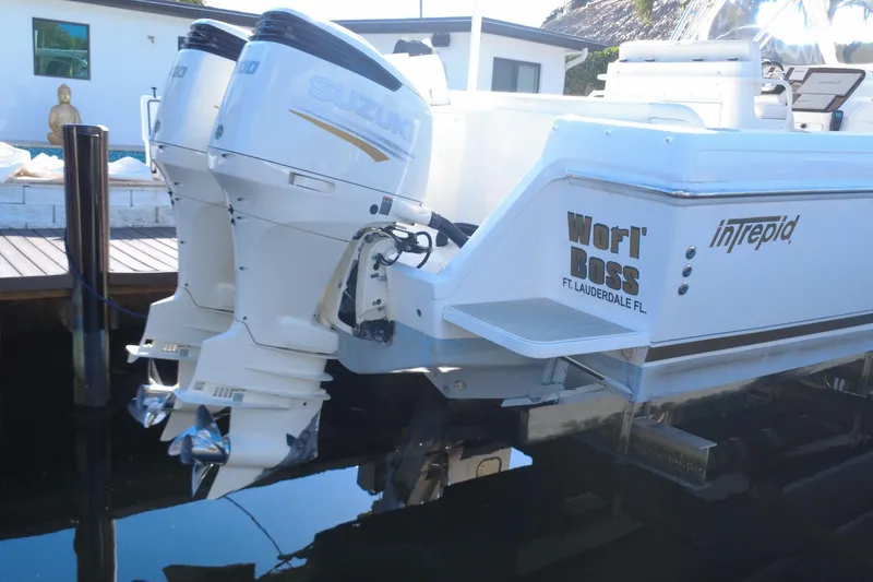 Slide: The Image of 2005 Intrepid 348 Walkaround boat with dual Suzuki outboard motors, docked in Fort Lauderdale. - 19