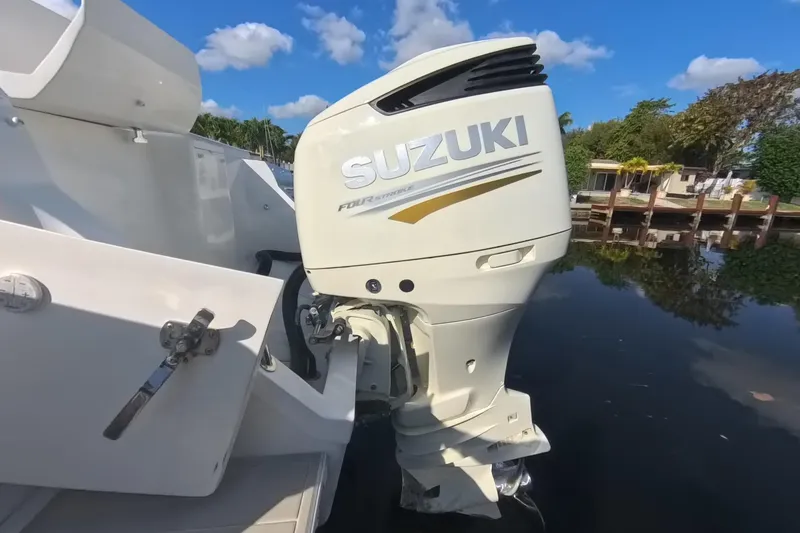 Slide: The Image of 2005 Intrepid 348 Walkaround with Suzuki outboard motor on calm water. - 20