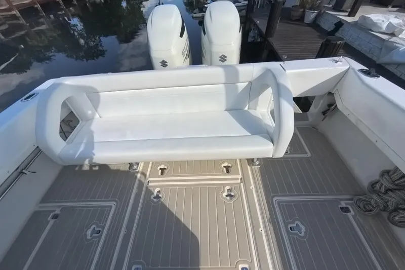 Slide: The Image of 2005 Intrepid 348 Walkaround boat with white seating and dual outboard engines. - 25
