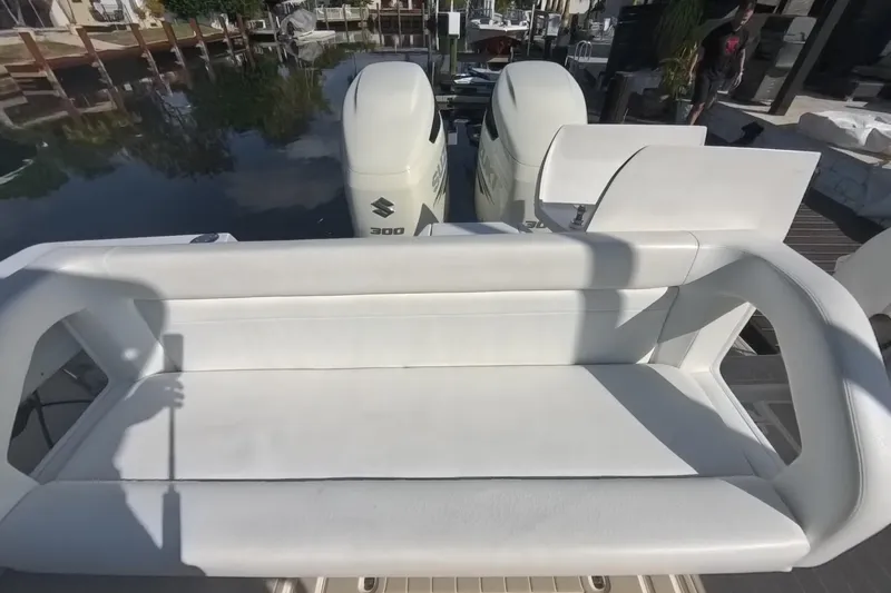 Slide: The Image of 2005 Intrepid 348 Walkaround boat with white seating and dual Suzuki 300 engines. - 26