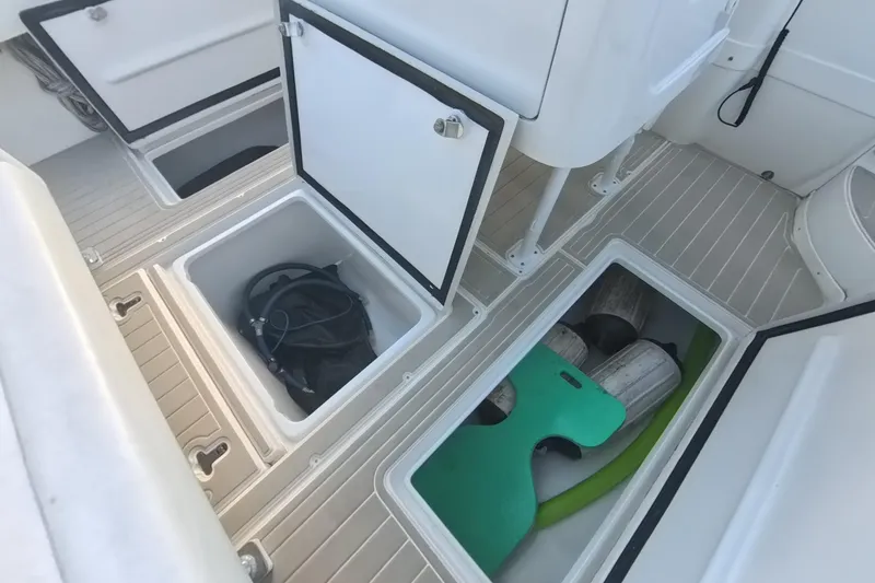Slide: The Image of 2005 Intrepid 348 Walkaround boat storage compartments with equipment and accessories. - 31