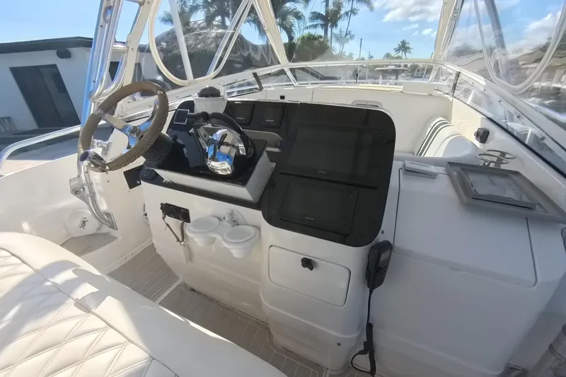Slide: The Image of 2005 Intrepid 348 Walkaround helm with steering wheel, controls, and navigation screens. - 35