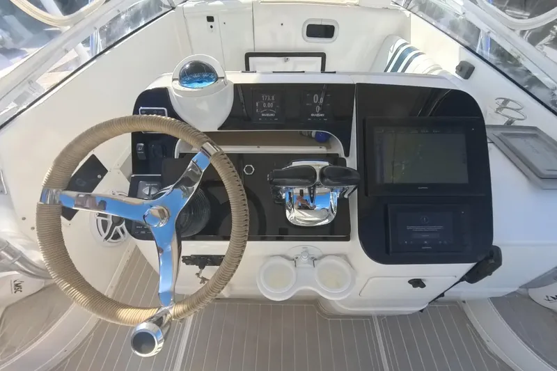 Slide: The Image of 2005 Intrepid 348 Walkaround helm with steering wheel and navigation controls. - 36