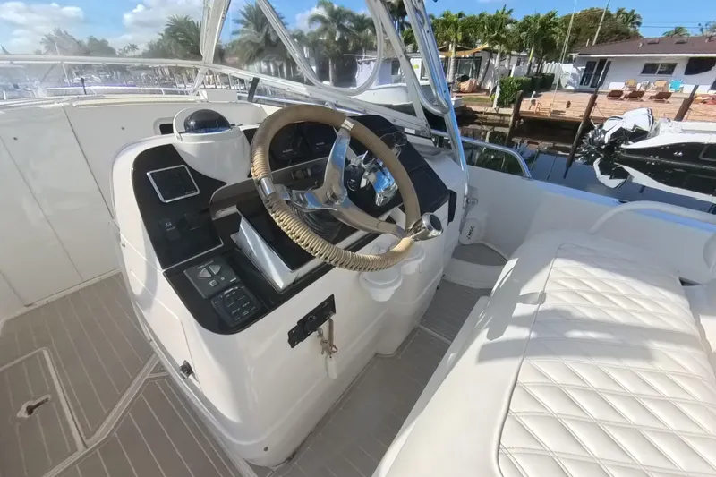 Slide: The Image of 2005 Intrepid 348 Walkaround boat helm with steering wheel and control panel. - 40
