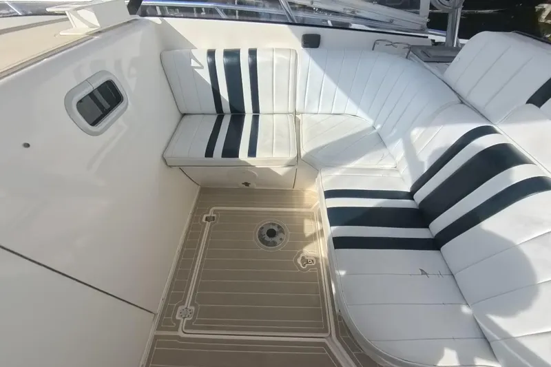 Slide: The Image of 2005 Intrepid 348 Walkaround boat interior with white and black striped seating. - 42