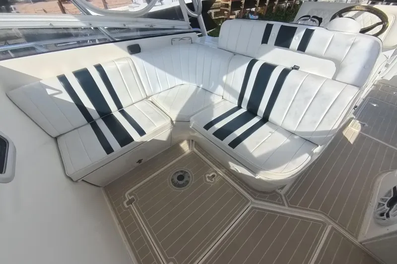Slide: The Image of 2005 Intrepid 348 Walkaround boat interior with white and black striped seating. - 44