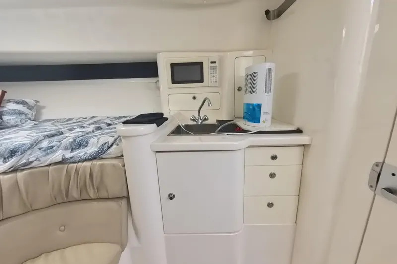 Slide: The Image of 2005 Intrepid 348 Walkaround cabin with bed, kitchenette, and microwave. - 55