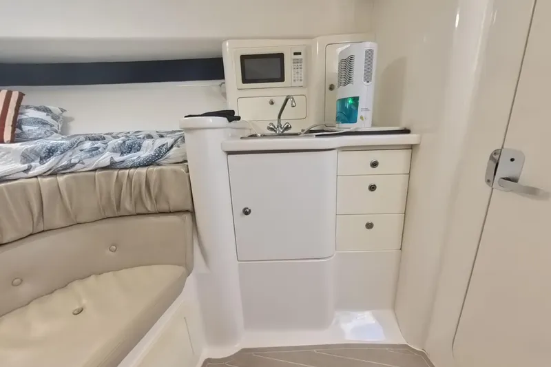 Slide: The Image of 2005 Intrepid 348 Walkaround cabin interior with kitchenette and bed. - 56