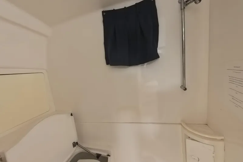 Slide: The Image of Interior of a 2005 Intrepid 348 Walkaround boat, featuring a compact cabin space. - 61