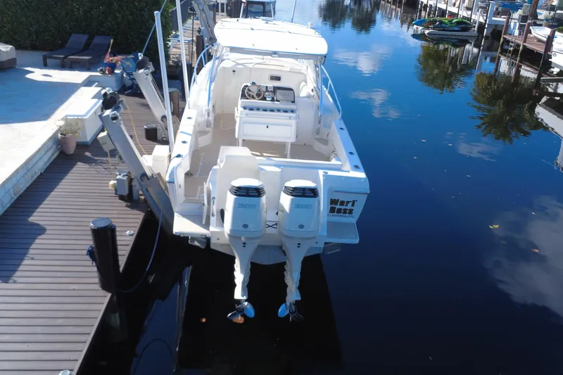 Slide: The Image of 2005 Intrepid 348 Walkaround boat docked with dual outboard engines. - 7