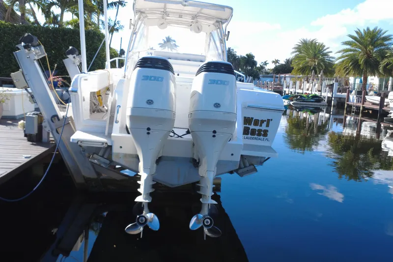 Slide: The Image of 2005 Intrepid 348 Walkaround boat with dual 300 HP engines docked in a marina. - 8
