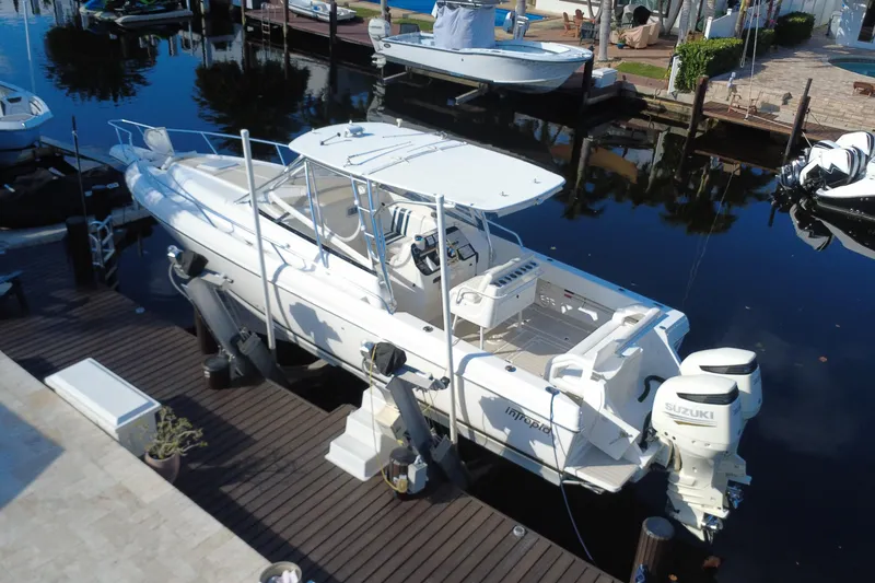 Slide: The Image of 2005 Intrepid 348 Walkaround boat docked with Suzuki engines, viewed from above. - 9