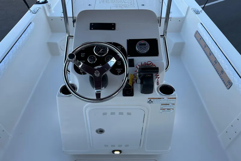 Slide: The Image of 2020 Carolina Skiff 21 LS boat console with steering wheel and controls. - 11
