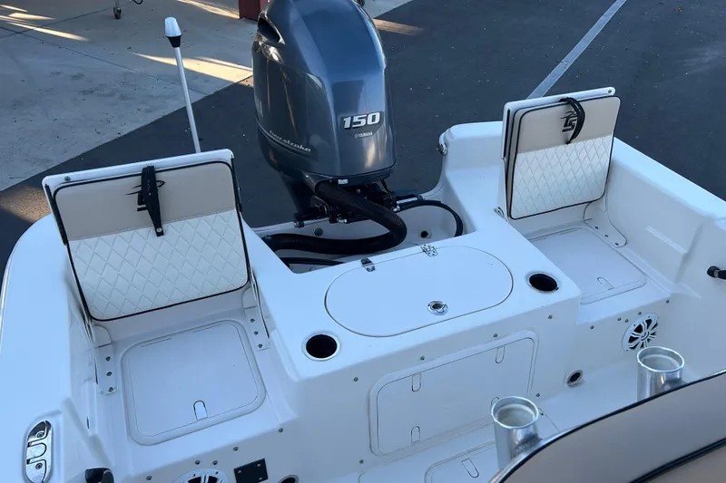 Slide: The Image of 2020 Carolina Skiff 21 LS boat with Yamaha 150 engine, featuring rear seating and storage. - 13