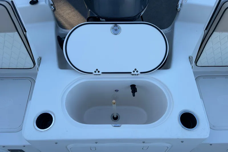 Slide: The Image of 2020 Carolina Skiff 21 LS boat interior with open storage compartment and cup holders. - 16