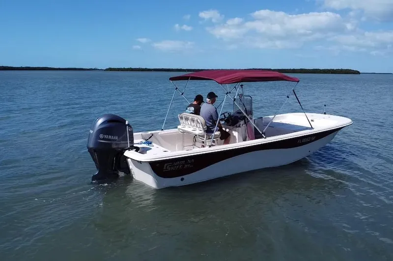 Slide: The Image of 2020 Carolina Skiff 21 LS boat with Yamaha engine on calm water. - 19