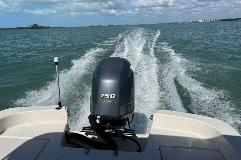 Slide: The Image of 2020 Carolina Skiff 21 LS boat with Yamaha 150 engine cruising on open water. - 20