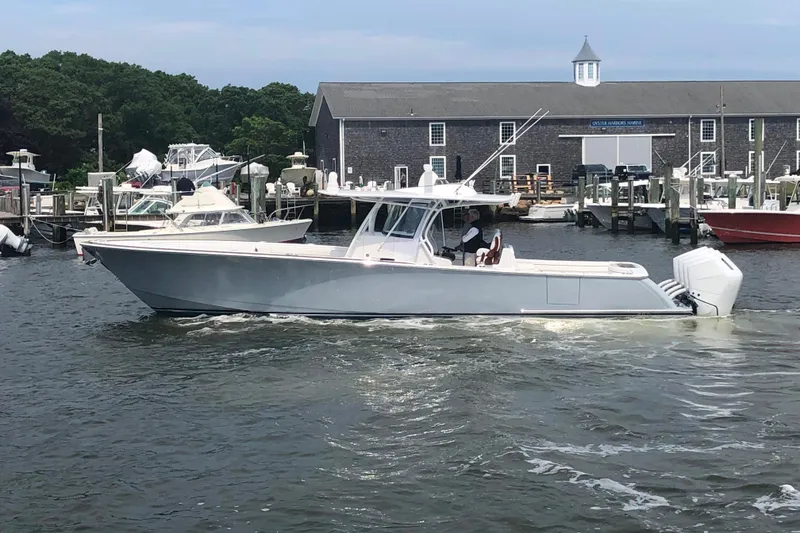 The Image of 2025 Valhalla Boatworks V-41 cruising near a marina with docked boats. - 0