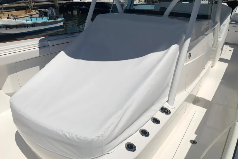 Slide: The Image of 2025 Valhalla Boatworks V-41 with covered seating area, docked at marina. - 17