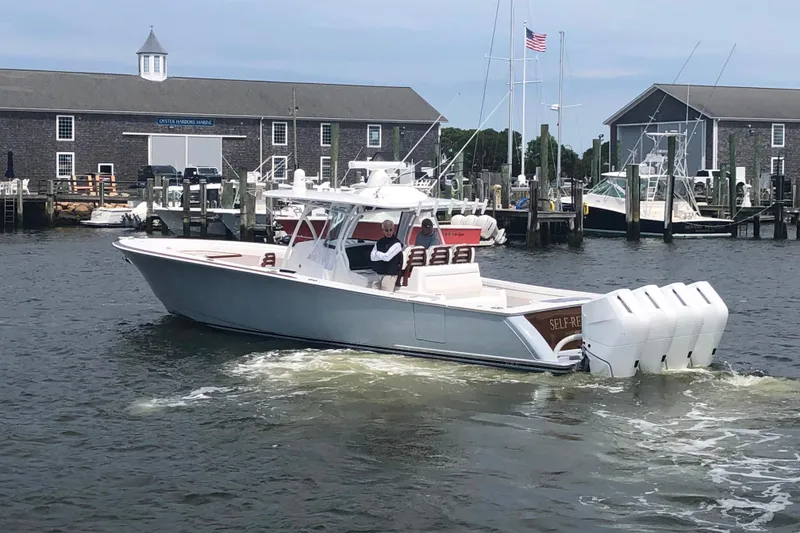 Slide: The Image of 2025 Valhalla Boatworks V-41 cruising near marina with multiple outboard engines. - 2