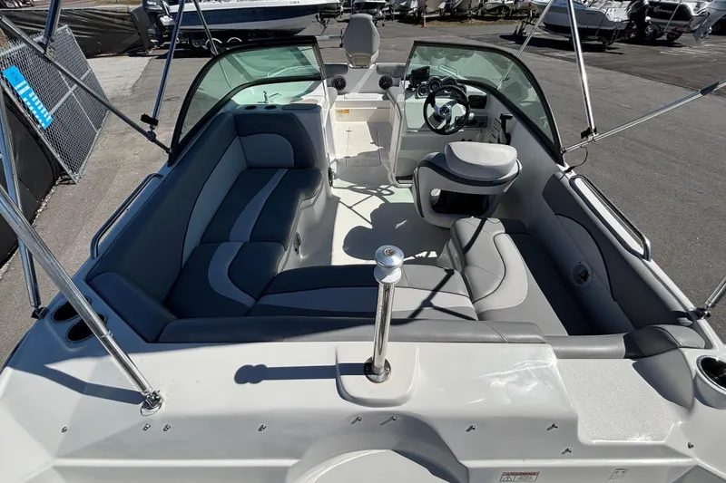 Slide: The Image of 2021 NauticStar 203 DC boat interior with seating and steering wheel. - 15