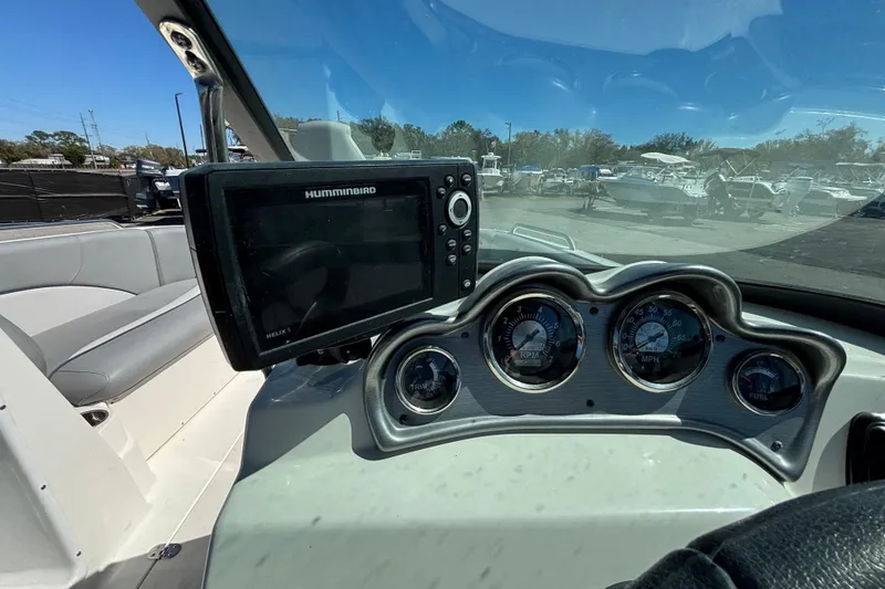 Slide: The Image of 2021 NauticStar 203 DC dashboard with Humminbird Helix 5 and gauges. - 23