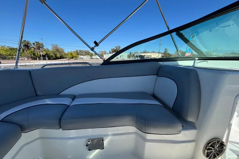 Slide: The Image of 2021 NauticStar 203 DC boat interior with gray seating and clear blue sky. - 28