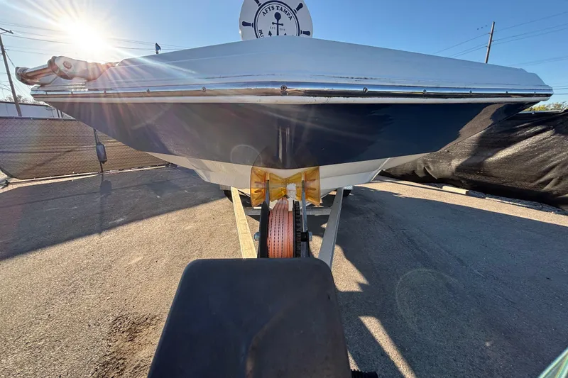 Slide: The Image of 2021 NauticStar 203 DC boat on trailer, blue and white, sunny day. - 3