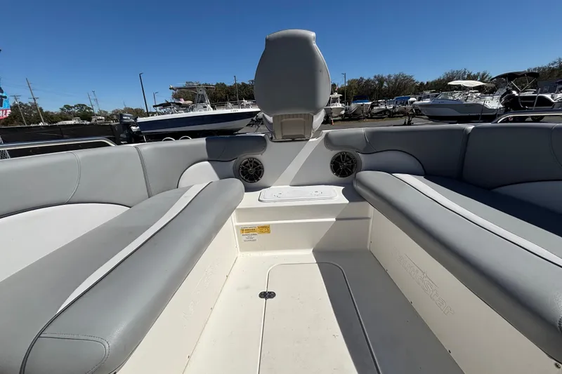 Slide: The Image of 2021 NauticStar 203 DC boat interior with gray seating and speaker system. - 31