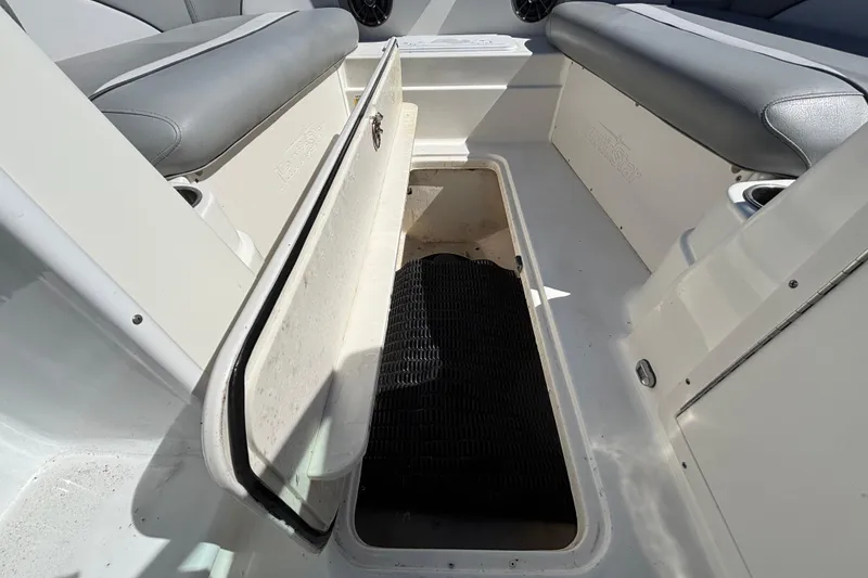 Slide: The Image of 2021 NauticStar 203 DC boat interior with open storage compartment. - 32