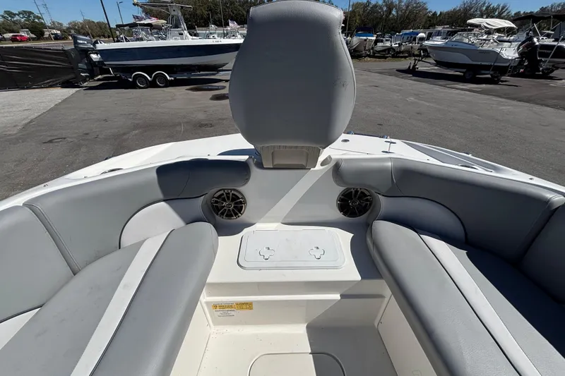 Slide: The Image of 2021 NauticStar 203 DC boat interior with gray seating and speaker system. - 33