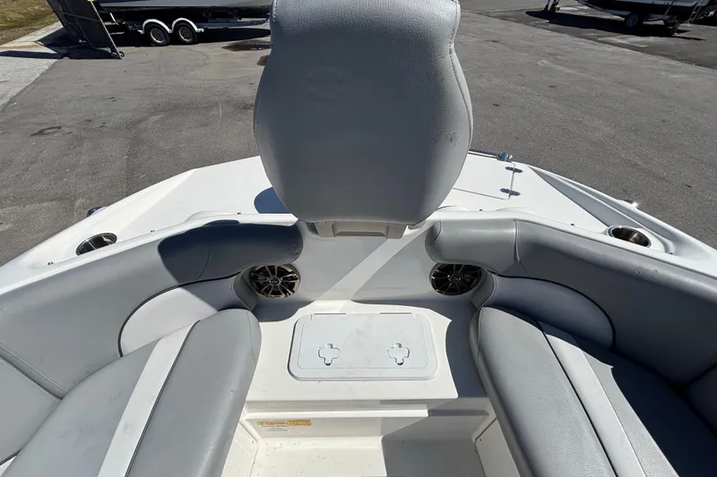 Slide: The Image of 2021 NauticStar 203 DC boat interior with gray seating and cup holders. - 36