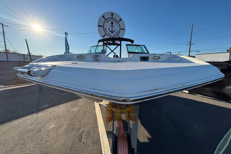 Slide: The Image of 2021 NauticStar 203 DC boat on trailer with canopy, displayed outdoors. - 4