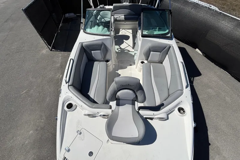 Slide: The Image of 2021 NauticStar 203 DC boat with gray seating and open deck layout. - 40
